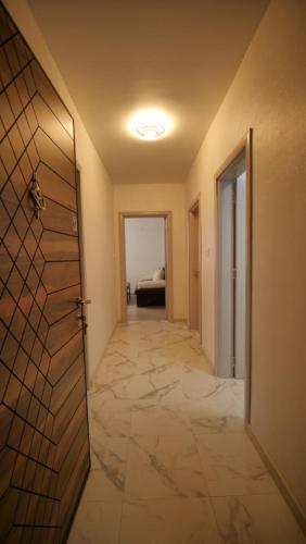 an empty hallway with a door and a bedroom at Апартамент за гости Симона in Smolyan