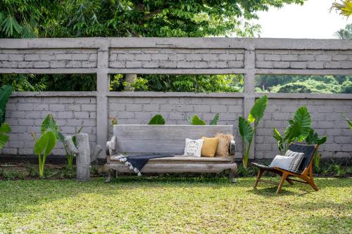 a couch and two chairs sitting in a yard at Salty Siesta Stays in Selong Belanak