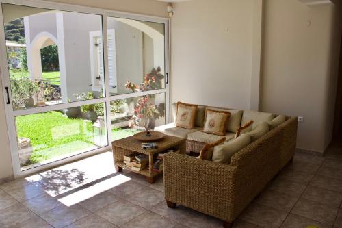 a living room with a couch and a table at Notos Luxury Studios in Katelios