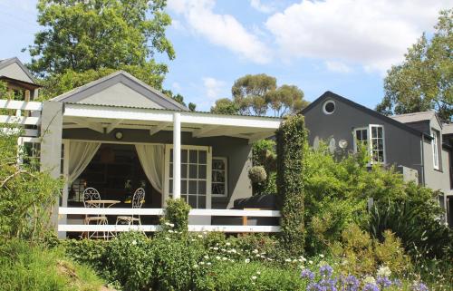a house with a porch with a table at Arumvale Country Retreat in Swellendam