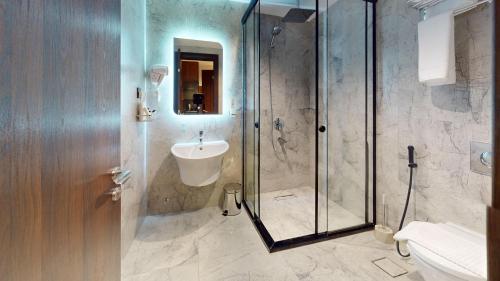 a bathroom with a shower and a sink at How inn Hotel in Al Madinah