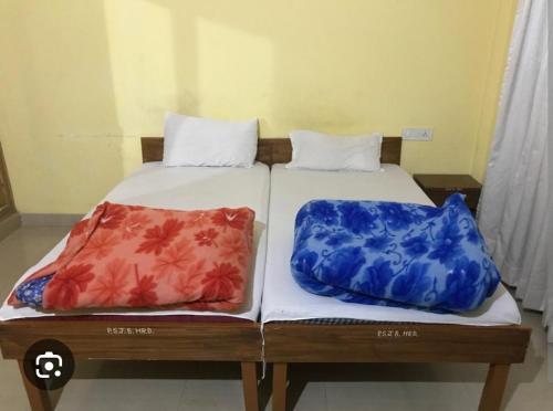 two beds sitting next to each other in a room at Sankat Mochan Hanuman Dham in Chhatikara