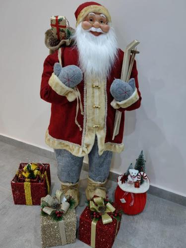 a statue of santa claus standing next to presents at New Wolf in Bran
