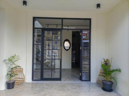 an open door of a building with two plants at BRICK HOUSE - Unique & Central in Selaparang