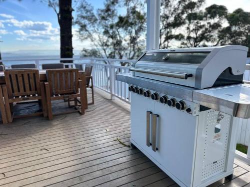 a grill on the deck of a house at Dreamy Lake Retreat & Sunsets in Lake Heights