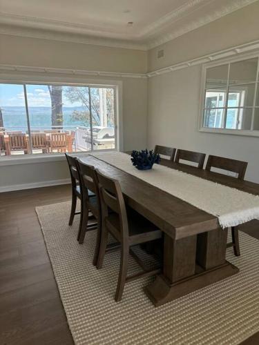 a dining room with a wooden table and chairs at Dreamy Lake Retreat & Sunsets in Lake Heights