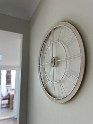 a clock hanging on a wall in a room at Dreamy Lake Retreat & Sunsets in Lake Heights