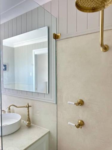 a bathroom with a sink and a mirror at Dreamy Lake Retreat & Sunsets in Lake Heights