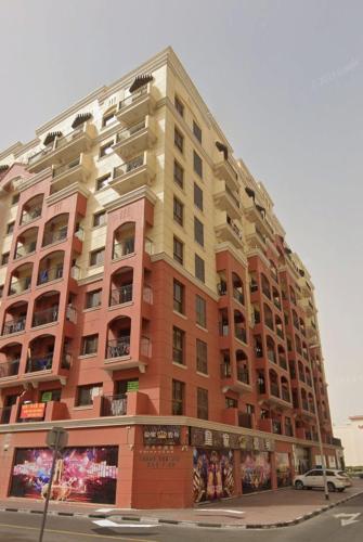 a large apartment building on the corner of a street at Dream International City Homes in Dubai
