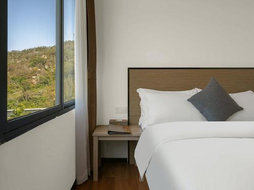 Katil atau katil-katil dalam bilik di Xiamen Wujing Mountain and Sea View Hotel