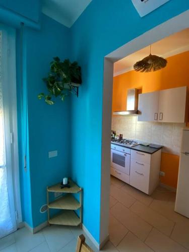 a kitchen with blue walls and a blue wall at Florentia Viola Apartament I in Florence