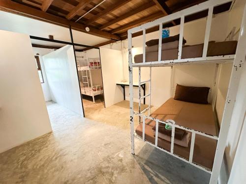 a room with two bunk beds and a desk at Pranee Bungalow in Koh Tao