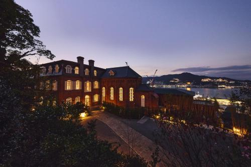 a large building with lights on it at night at Hotel Indigo Nagasaki Glover Street by IHG in Nagasaki