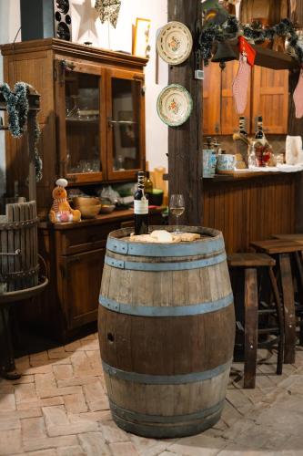a wooden barrel with a bottle of wine in a kitchen at Ruralna kuća za odmor Gerstmajer in Zmajevac