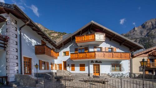a house with wooden balconies on a mountain at Italianway - Belvedere 28 - Stella Bianca in Valdidentro