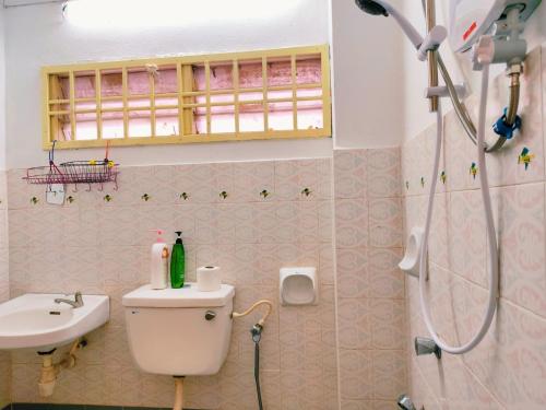 a bathroom with a toilet and a sink and a shower at Area Indahpura or Taman Bersatu Kulai 3-4BR near AEON Airport JPO in Kulai
