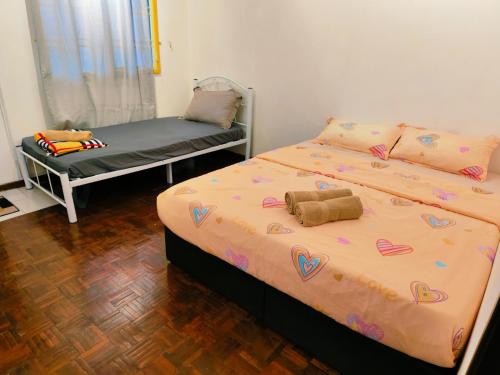 a bedroom with a bed with hearts on it at Area Indahpura or Taman Bersatu Kulai 3-4BR near AEON Airport JPO in Kulai