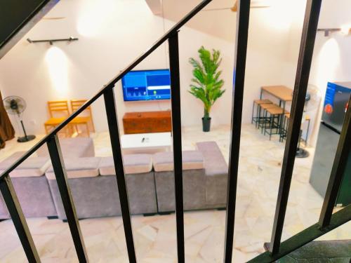 a living room with a couch and a table at Area Indahpura or Taman Bersatu Kulai 3-4BR near AEON Airport JPO in Kulai