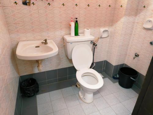 a bathroom with a toilet and a sink at Area Indahpura or Taman Bersatu Kulai 3-4BR near AEON Airport JPO in Kulai