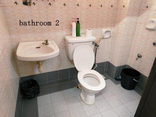a bathroom with a toilet and a sink at Area Indahpura or Taman Bersatu Kulai 3-4BR near AEON Airport JPO in Kulai