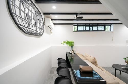 a dining room with a black table and black chairs at Tonight Homestay South Shanxi Road Shanghai in Shanghai