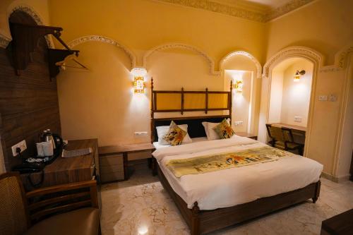 a bedroom with a bed and a desk and a bed sidx sidx sidx at Captain Villa Heritage House in Varanasi