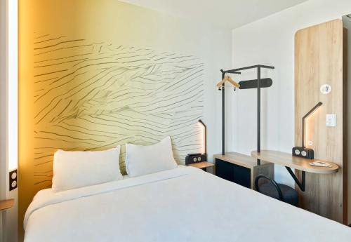 a bedroom with a white bed and a desk at B&B HOTEL Champigny-sur-Marne in Champigny-sur-Marne