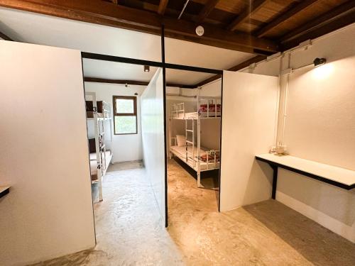 a room with white walls and a glass door at Pranee Bungalow in Koh Tao