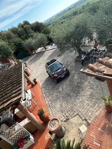 a car parked in a parking lot next to a house at Agrihome Di Alberto Giuseppe Gulotta B&B Bella Vista Appartamento Salvia in Massarosa