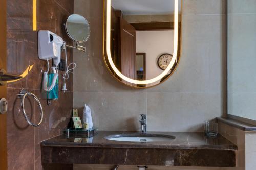 a bathroom with a sink and a mirror at GreenPak Hotel Hunza in Karimabad Hunza