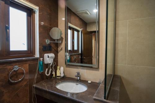 a bathroom with a sink and a shower at GreenPak Hotel Hunza in Karimabad Hunza
