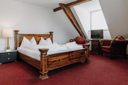 a bedroom with a large wooden bed and a chair at Seldas in Schaffhausen