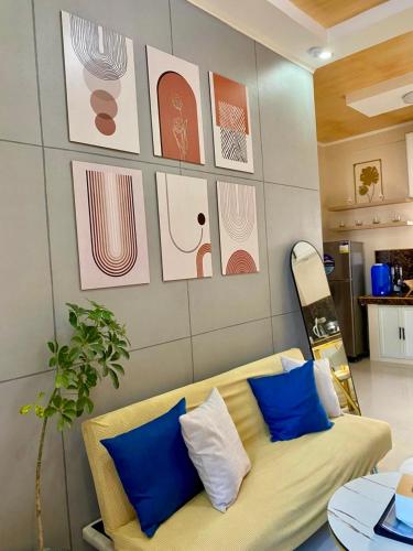 a living room with a couch and some pictures on the wall at FYLL Homes Francheska Suite Calvario St Cavinti Town Proper in Cavinti