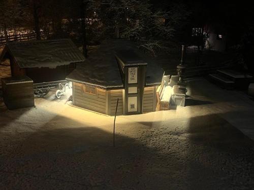 a small building with a light in the dark at Arctic apartment Tønsvik in Tromsø