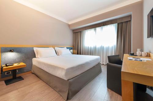 a hotel room with a bed and a desk at Best Western Hotel Quattrotorri in Perugia