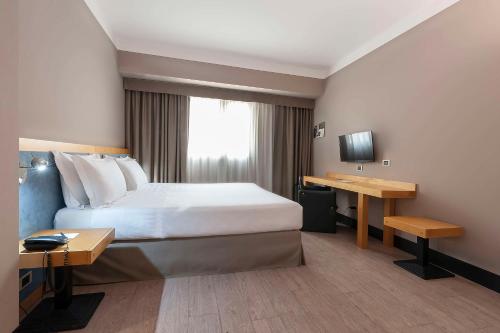 a hotel room with a bed and a desk at Best Western Hotel Quattrotorri in Perugia