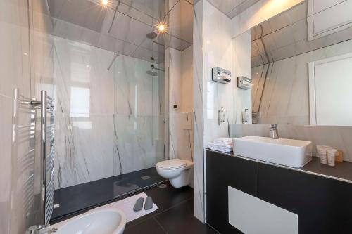 a white bathroom with a sink and a toilet at Best Western Hotel Quattrotorri in Perugia