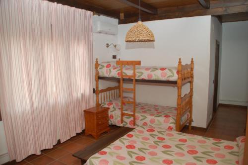 a bedroom with two bunk beds in a room at Casa rural Dalia in Sierra de Fuentes