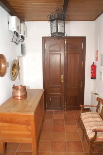 a room with a table and a wooden door at Casa rural Dalia in Sierra de Fuentes