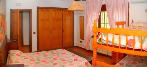 a bedroom with a wooden bunk bed and a chair at Casa rural Dalia in Sierra de Fuentes