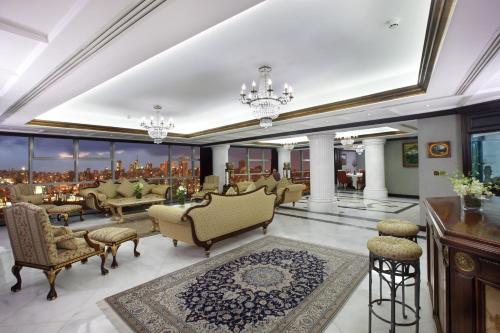 a living room with couches and chairs in a building at Habtoor Metropolitan Palace Hotel in Beirut