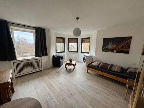 a living room with a bed and a table at Schöne Wohnung mit Erker in Gieleroth