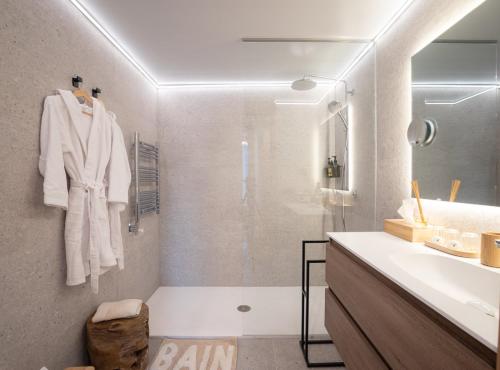 a bathroom with a shower and a sink and a tub at Isard Homes by Select Rentals in El Tarter