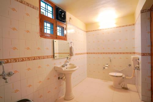 a bathroom with a sink and a toilet at Chirping Hills Resort,Bhimtal in Bhīm Tāl