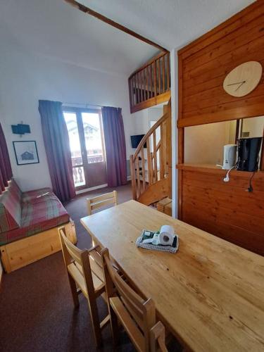 une salle à manger avec une table et des chaises en bois dans l'établissement RPP C208 - Apt 3 pièces duplex 6 8 pers, à Tignes