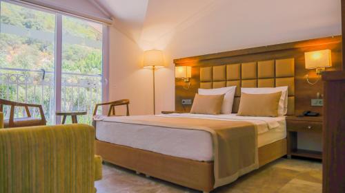 A bed or beds in a room at Ölüdeniz Turquoise Hotel - All Inclusive