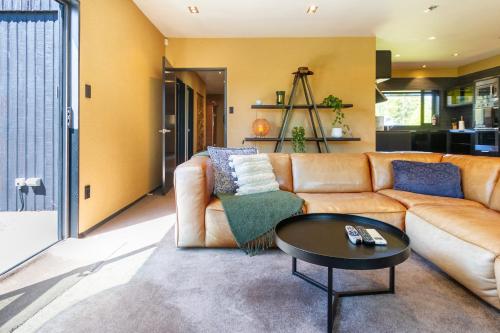 a living room with a couch and a table at Families and Groups, Chch Airport, Spa Pool in Christchurch