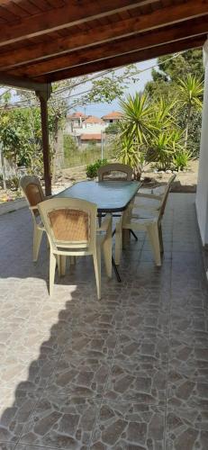 a picnic table and chairs on a patio at Maria's Home in Kakóvatos