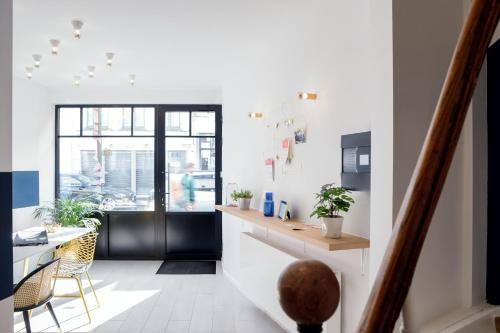 a kitchen with a counter and a table and chairs at Urban Walls in Brussels