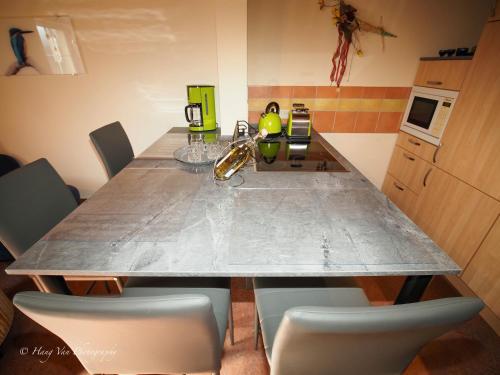 a kitchen with a table with chairs and a counter top at Birkenhof Pließkowitz in Malschwitz